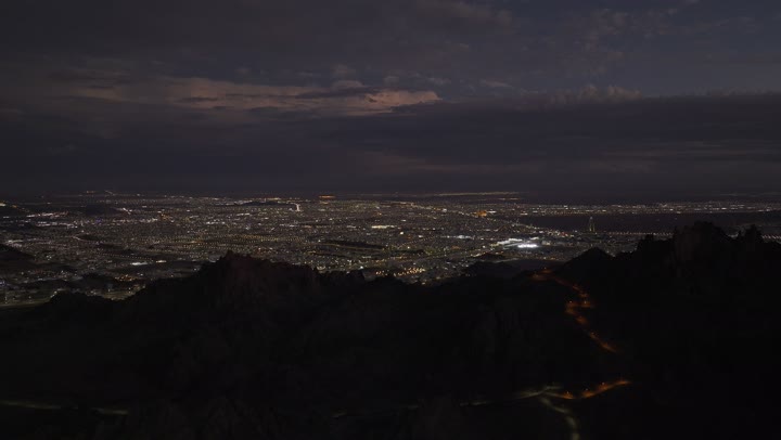 Urban growth and development of buildings and facilities, vehicle traffic on roads and streets in the Kingdom of Saudi Arabia, aerial drone photography of the city of Hail at night, famous tourist attractions, improvement and preparation of infrastructure in cities