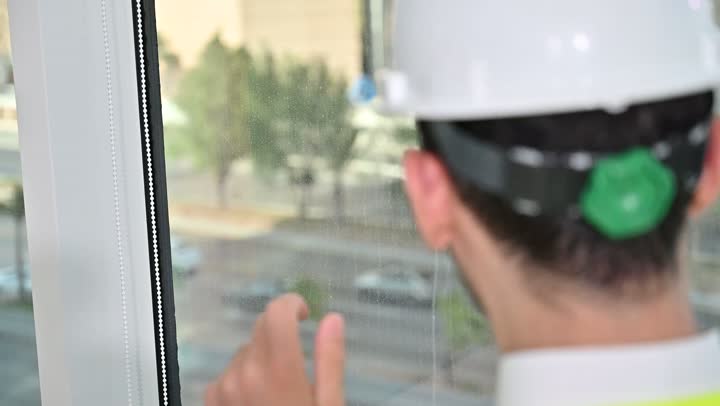 الاهتمام بالتطور العمراني بسواعد المهندسين السعوديين, مهندس عربي خليجي سعودي يرتدي سترة العمل وخوذة الحماية البيضاء ينجز المهام اليومية في المكتب، متابعة مخطط المشروع الهندسي وتدقيقه, مفهوم الهندسة والإنشاءات المعمارية، مشاريع إعمارية سعودية وطنية