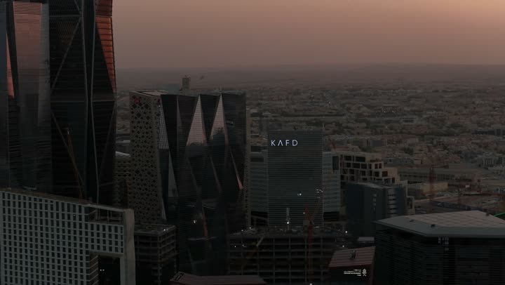 Modern and sophisticated towers and skyscrapers, famous commercial and economic landmarks in the Saudi capital, King Abdullah Financial District (KAFD), economic and urban renaissance, aerial drone photography of the Riyadh skyline at sunset