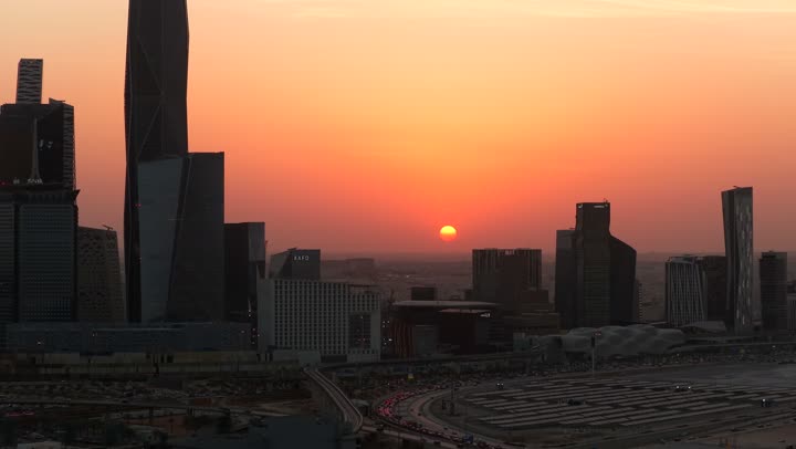 Modern and sophisticated towers and skyscrapers, famous commercial and economic landmarks in the Saudi capital, King Abdullah Financial District (KAFD), economic and urban renaissance, aerial drone photography of the Riyadh skyline at sunset
