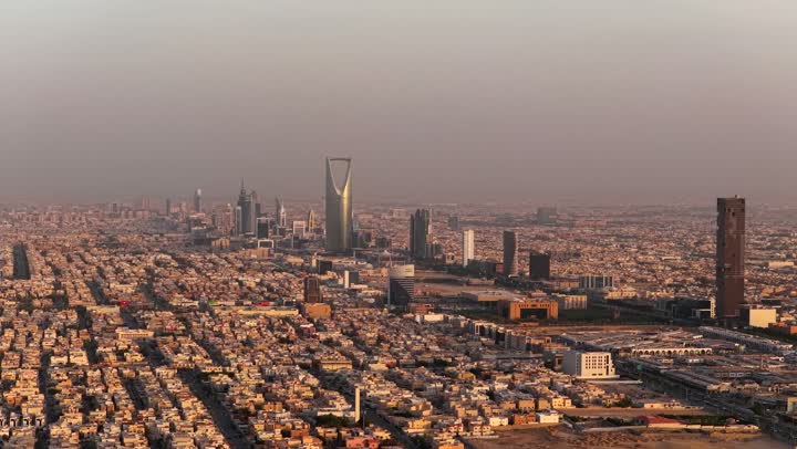 The economic and cultural renaissance in the Kingdom of Saudi Arabia, urban development and growth in cities and neighborhoods, aerial drone photography of roads and streets, the Kingdom Tower and Al Faisaliah Tower in Riyadh, towers and skyscrapers built in a modern style, a famous tourist attraction in the capital