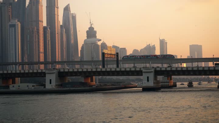 Famous tourist attractions in Dubai, the waterfront overlooking the Arabian Gulf, sailing in the harbor and yacht marina in Dubai Marina, the architectural art of the buildings and structures overlooking the sea, the progress and urban growth of towers and skyscrapers in the United Arab Emirates