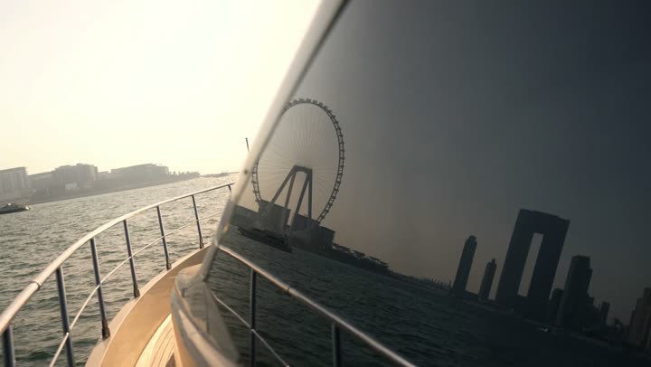 Famous tourist attractions in Dubai, the waterfront overlooking the Arabian Gulf, sailing in the harbor and yacht marina in Dubai Marina, the architectural art of the buildings and structures overlooking the sea, the progress and urban growth of towers and skyscrapers in the United Arab Emirates