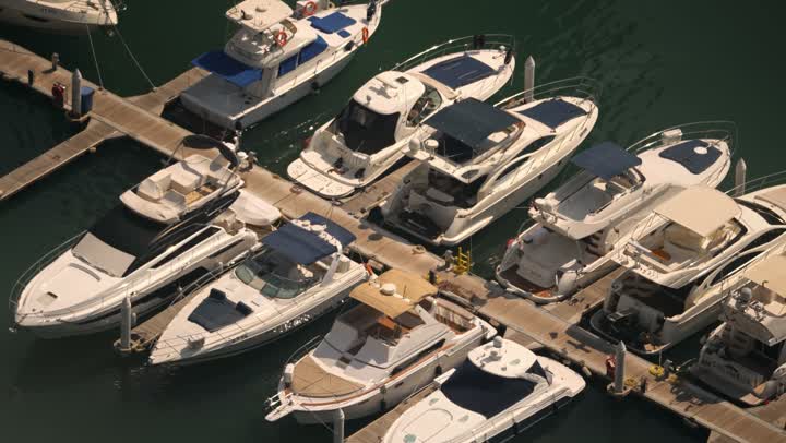 Famous tourist attractions in Dubai, the waterfront overlooking the Arabian Gulf, sailing in the harbor and yacht marina in Dubai Marina, the architectural art of the buildings and structures overlooking the sea, the progress and urban growth of towers and skyscrapers in the United Arab Emirates