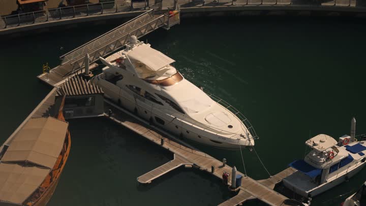 Famous tourist attractions in Dubai, the waterfront overlooking the Arabian Gulf, sailing in the harbor and yacht marina in Dubai Marina, the architectural art of the buildings and structures overlooking the sea, the progress and urban growth of towers and skyscrapers in the United Arab Emirates