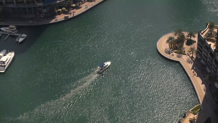 Dubai's famous tourist attractions, the waterfront overlooking the Arabian Gulf, sailing in the harbor and yacht marina in Dubai Marina, the architectural art of the buildings and structures overlooking the sea, the progress and urban growth of towers and skyscrapers in the United Arab Emirates