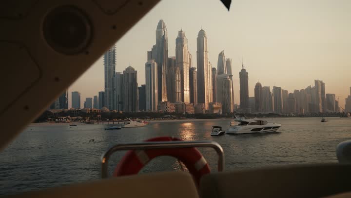 The urban growth of towers and skyscrapers in the United Arab Emirates, famous tourist attractions in Dubai, the waterfront overlooking the Arabian Gulf coast, sailing in the harbor and yacht marina in Dubai Marina, the architectural art of buildings and structures overlooking the sea