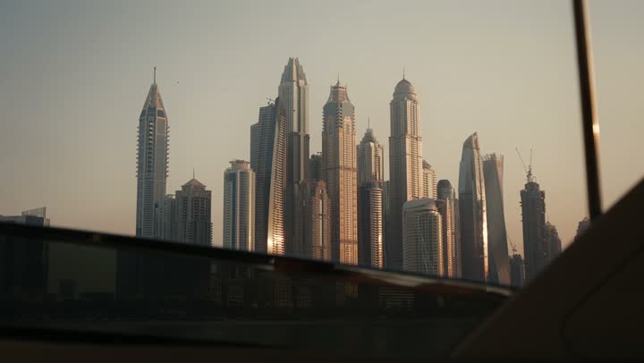 The urban growth of towers and skyscrapers in the United Arab Emirates, famous tourist attractions in Dubai, the waterfront overlooking the Arabian Gulf coast, sailing in the harbor and yacht marina in Dubai Marina, the architectural art of buildings and structures overlooking the sea