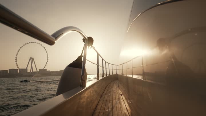 The architectural art of buildings and structures overlooking the sea, the urban growth of towers and skyscrapers in the United Arab Emirates, famous tourist attractions in Dubai, the waterfront overlooking the Arabian Gulf coast, sailing in the harbor and yacht marina in Dubai Marina