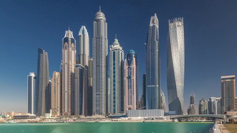 The architectural art of buildings and structures overlooking the sea, the growth and urban development of towers and skyscrapers in the United Arab Emirates, famous tourist attractions in Dubai, the waterfront overlooking the Arabian Gulf coast, the harbor and yacht marina in Dubai Marina