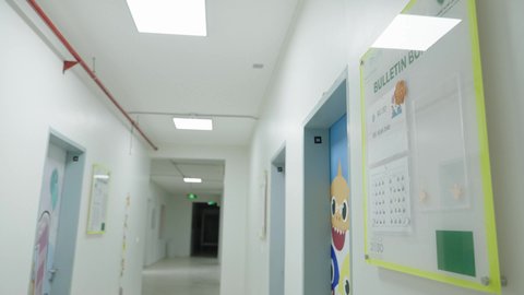 An interior corridor in one of the modern schools in the Kingdom of Saudi Arabia, contemporary interior design, organized educational environment, school schedule and activities board.