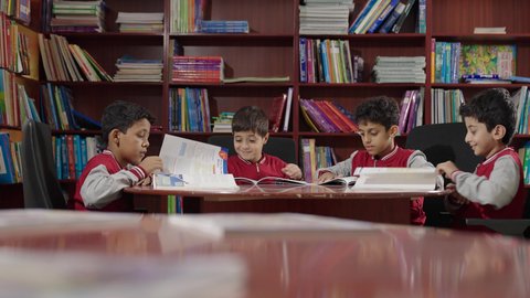 Education in the Kingdom of Saudi Arabia, Arab Saudi Gulf students in the school library, enjoying reading school books, completing school assignments.