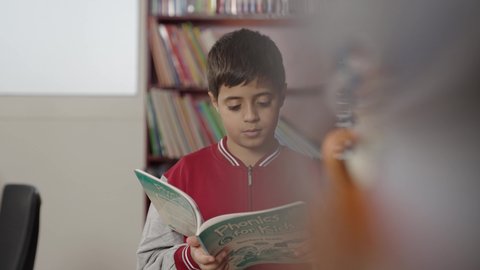 Education in the Kingdom of Saudi Arabia, Arab Saudi Gulf students in the school library, enjoying reading school books, completing school assignments.