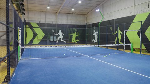 A spacious playground in one of the modern schools in the Kingdom of Saudi Arabia, practicing sports activities and football, with a green grass surface, focusing on health and physical fitness.