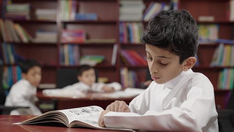التعليم في المملكة العربية السعودية، مجموعة من طلاب عربية سعودية خليجية في المكتبة المدرسية، الاستمتاع بقراءة الكتب المدرسية، تأدية الواجبات المدرسية