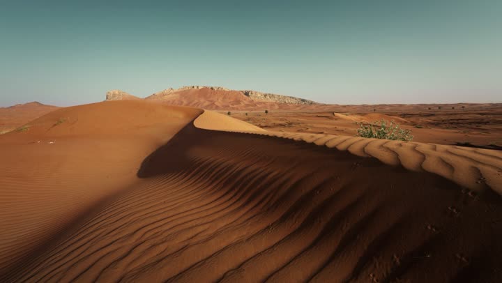 Soft golden dunes and natural terrain in the United Arab Emirates, harsh and dry weather in the arid lands, landscapes and soft golden sands in the desert, sand formations and formations in the desert, nature background