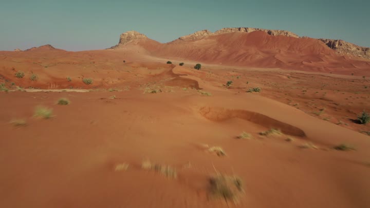 Soft golden dunes and natural terrain in the United Arab Emirates, harsh and dry weather in the arid lands, landscapes and soft golden sands in the desert, sand formations and formations in the desert, nature background