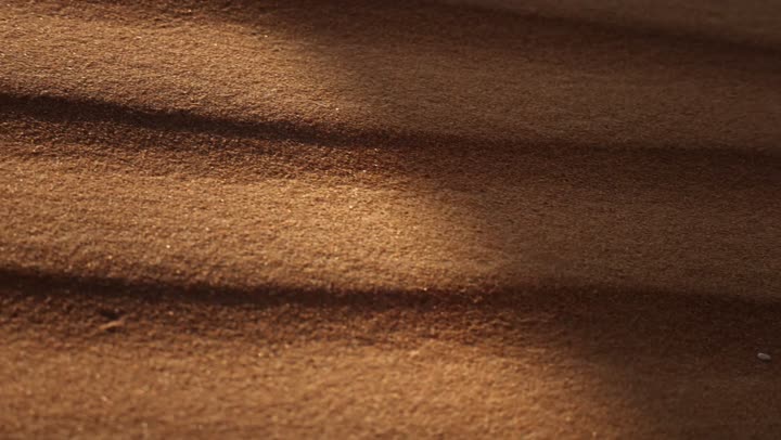 Soft golden dunes and natural terrain in the United Arab Emirates, harsh and dry weather in the arid lands, landscapes and soft golden sands in the desert, sand formations and formations in the desert, nature background