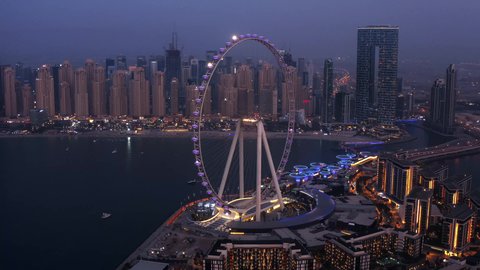 The Ain Dubai Ferris wheel on Bluewaters Island, a famous tourist attraction on Jumeirah Beach in the city of Dubai, fun family and youth entertainment activities and events at night time, a view of the Arabian Gulf coast in the United Arab Emirates