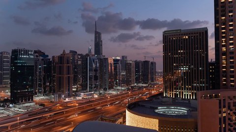 Famous tourist attractions in the United Arab Emirates, attracting tourists from all over the world, paved streets and roads, car traffic, buildings and commercial facilities in Dubai, the architectural art of building towers and skyscrapers in a modern style