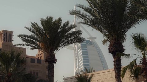 The tourist destination in the United Arab Emirates, the architectural art of towers and skyscrapers, attracting and attracting tourists from all over the world, the Burj Al Arab Hotel in Dubai illuminated at night, urban growth and development on the coast of the Arabian Gulf