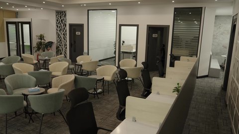 An indoor meeting room with a modern design featuring a luxurious table and chairs, office rooms with luxurious designs and interior decorations, the modern contemporary design of offices in Saudi companies, windows and glass facades.