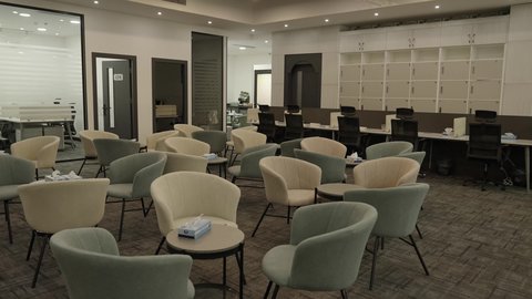 The modern contemporary design of offices in Saudi companies, office rooms with luxurious designs and interior decorations, a spacious meeting room with a table surrounded by chairs.