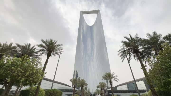Photography of the famous Kingdom Tower in Riyadh, towers and skyscrapers, growth, development and urban progress, famous buildings and commercial landmarks in Saudi Arabia, advanced and modern architectural art, photography of the famous Kingdom Tower in Riyadh