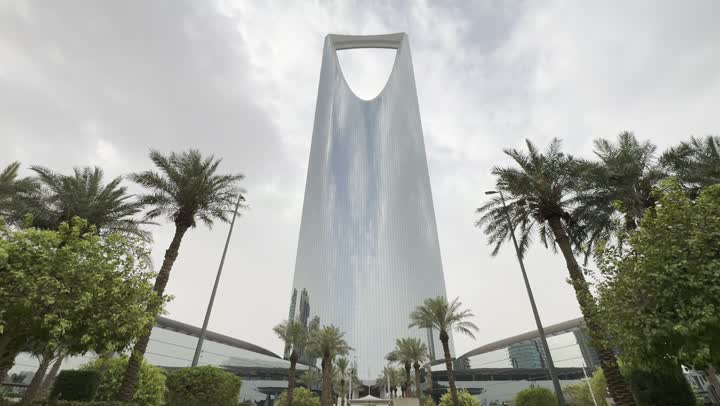 Photography of the famous Kingdom Tower in Riyadh, towers and skyscrapers, growth, development and urban progress, famous buildings and commercial landmarks in Saudi Arabia, advanced and modern architectural art, photography of the famous Kingdom Tower in Riyadh