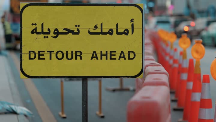 Guidance signs and warning traffic signals during the construction of new roads, construction works, and urban development in Saudi Arabia, road and traffic networks, connecting city neighborhoods and distant areas and reducing distances, urban and architectural progress, adherence to traffic and driving guidelines.
