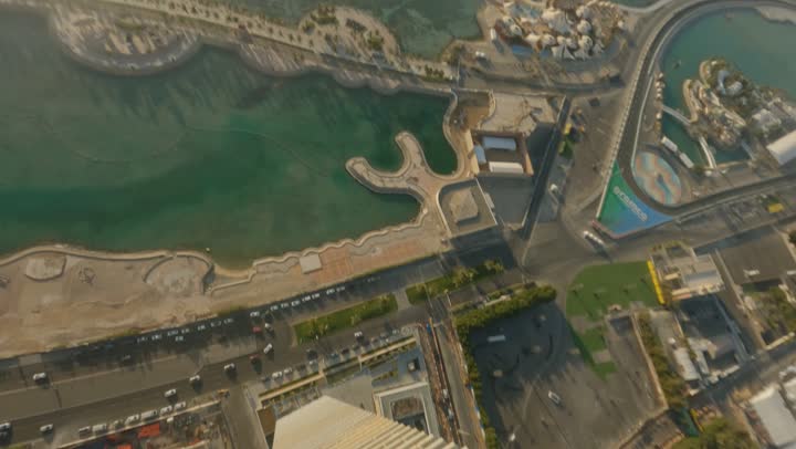 Architectural design for a tower that resembles twisting or rotation, modern and advanced architectural engineering art, drone photography of a contemporary area with skyscrapers and towers in the city of Jeddah, the growth and urban advancement of skyscrapers in the Kingdom of Saudi Arabia, the main destination for finance and business.