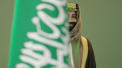 The day we began 1727 AD, the anniversary of the founding of the first Saudi state on February 22, Flag Day on March 11, the Saudi National Day commemoration on September 23, a portrait of a Saudi Arabian Gulf man wearing a bisht, ghutra and agal on the founding day, holding a sword in his hand and standing next to the Saudi flag