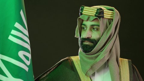 Saudi National Day commemoration, September 23, Flag Day, March 11, portrait of a Saudi Arabian Gulf man wearing a bisht, ghutra, and igal, Founding Day, raising the Saudi flag, the day we began in 1727 AD, the anniversary of the founding of the first Saudi state on February 22