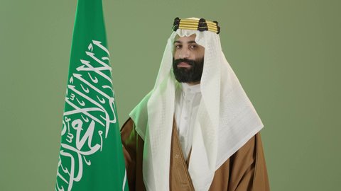 The day we began 1727 AD, Saudi National Day commemoration September 23, the anniversary of the founding of the first Saudi state on February 22, a portrait of a Saudi Arabian Gulf man wearing a bisht, ghutra and agal on the founding day raising the Saudi flag, Flag Day March 11