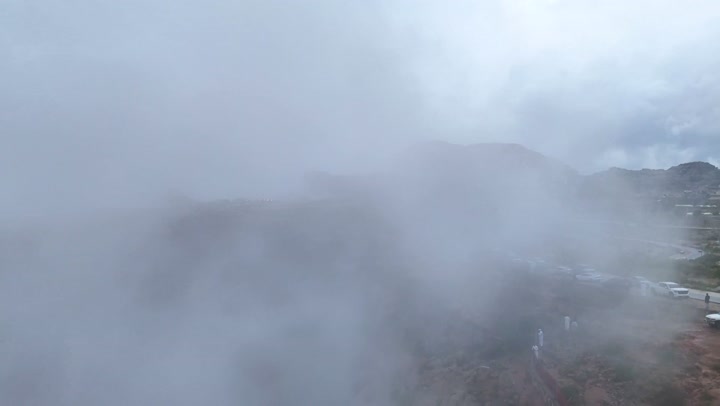 Tourist attractions and destinations for visitors from around the world, drone photography of the Al-Habala tourist park in the Asir region, the hills and mountainous elevations in Saudi Arabia, rock formations and structures, natural tourist landmarks in the Kingdom, the cloudy sky.