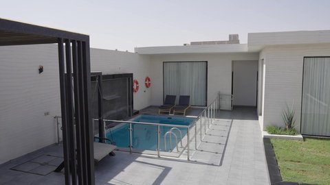 Luxury home furnishings in a chalet, modern interior design for seating areas, suites furnished with all high-end furnishings, elegant interior design for villas and residential apartments in the Kingdom of Saudi Arabia, and a quiet outdoor seating area in front of the swimming pool.