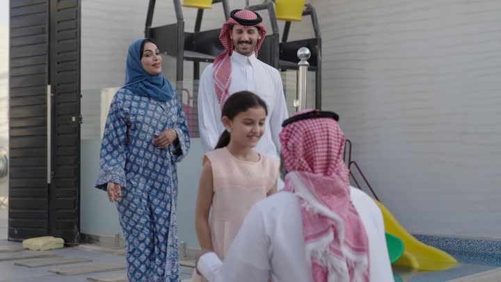 Chalet and recreational resort in the Kingdom, enjoying the summer vacation with the family, gestures of happiness and pleasure, spending a fun and refreshing time in the summer, a family atmosphere full of love, a smiling Saudi Arabian Gulf family walking in the park