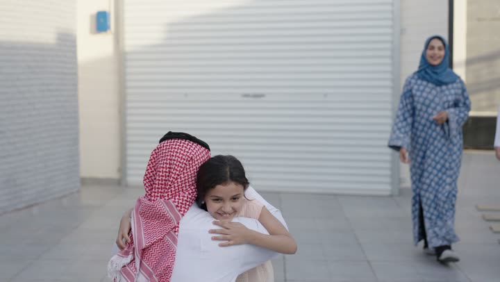 شاليه ومنتجع ترفيهي في المملكة، الاستمتاع بالإجازة الصيفية برفقة العائلة، ايماءات السعادة والسرور، قضاء وقت ممتع ومنعش في فصل الصيف، الأجواء العائلية المليئة بالحب، عائلة عربية خليجية سعودية مبتسمة تمشي في المنتزه