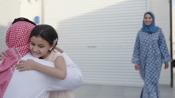 Chalet and recreational resort in the Kingdom, enjoying the summer vacation with the family, gestures of happiness and pleasure, spending a fun and refreshing time in the summer, a family atmosphere full of love, a smiling Saudi Arabian Gulf family walking in the park