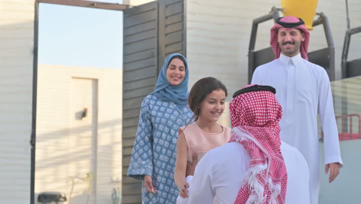 Chalet and recreational resort in the Kingdom, enjoying the summer vacation with the family, gestures of happiness and pleasure, spending a fun and refreshing time in the summer, a family atmosphere full of love, a smiling Saudi Arabian Gulf family walking in the park