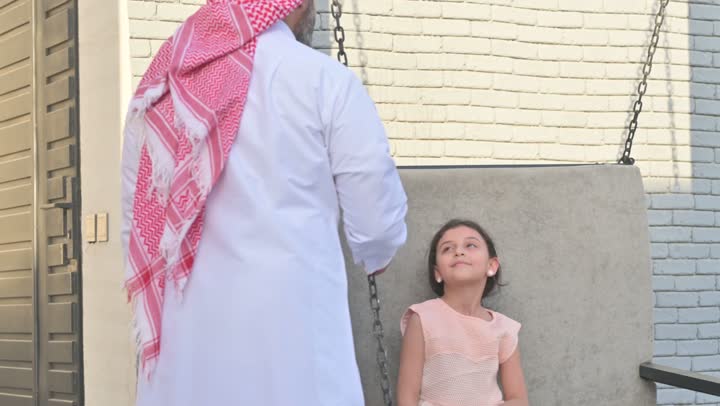 Chalet and recreational resort in the Kingdom, enjoying the summer vacation with the family, gestures of happiness and pleasure, spending a fun and refreshing time in the summer, a family atmosphere full of love, a smiling Saudi Arabian Gulf family walking in the park