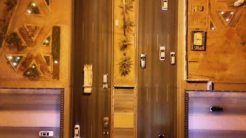 Transportation and communication activities on the main streets and roads in the Kingdom of Saudi Arabia, aerial drone photography of organized traffic movement, the growth and development of infrastructure, and the economic and urban renaissance of the capital's skyline.