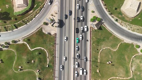 Focus on planting trees and green plants, the economic and urban renaissance of the capital's skyline, the movement of transportation and communication means on the streets and main roads in the Kingdom of Saudi Arabia, aerial drone photography of organized traffic movement of cars, and the growth and development of infrastructure.