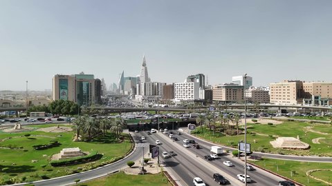 Aerial drone footage of organized traffic, infrastructure growth and development, modern and sophisticated urban development, the economic and urban renaissance of the capital's skyline, and transportation traffic on the main streets and roads in the Kingdom of Saudi Arabia.