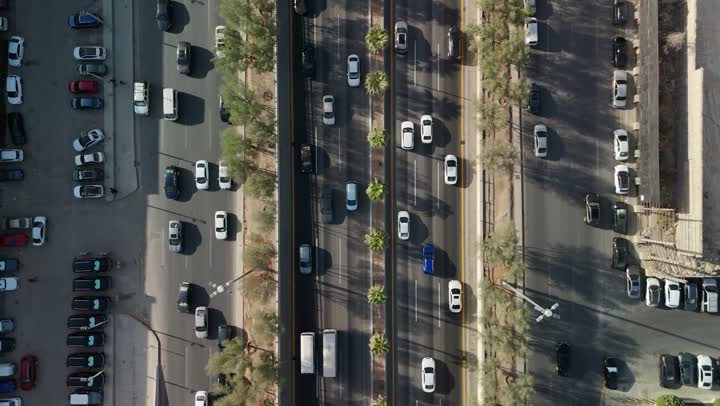 The economic and urban renaissance of the capital's skyline, the movement of transportation and communication means on the streets and main roads in the Kingdom of Saudi Arabia, aerial drone photography of organized traffic movement of cars, the growth and development of infrastructure