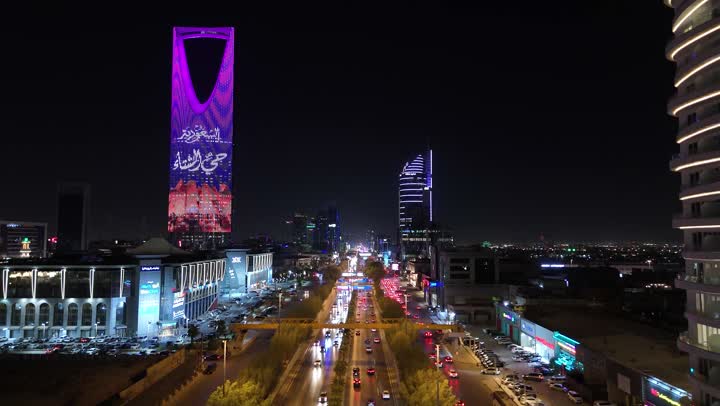 Famous commercial buildings and landmarks, modern and advanced architectural art, aerial drone footage of the famous illuminated Kingdom Tower in Riyadh, towers and skyscrapers, growth, development and urban progress, lifestyle in the capital, Saudi Arabia's winter district