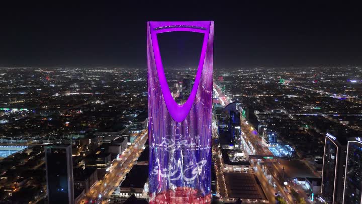 Famous commercial buildings and landmarks, modern and advanced architectural art, aerial drone footage of the famous illuminated Kingdom Tower in Riyadh, towers and skyscrapers, growth, development and urban progress, lifestyle in the capital, Saudi Arabia's winter district