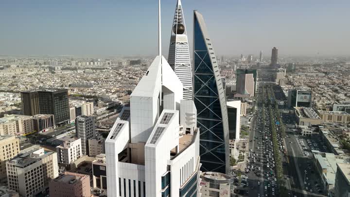 Al-Wasil Tower and the Ministry of Islamic Affairs, Endowments, Call and Guidance in Al-Ulaya during the day, architectural art of buildings and skyscrapers in Riyadh, aerial drone photography of famous places and landmarks in the Kingdom of Saudi Arabia
