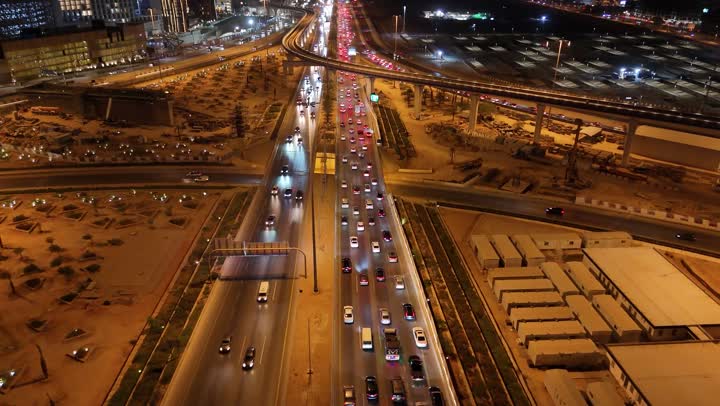 The concept of interest in infrastructure in the city of Riyadh, towers and skyscrapers in the Kingdom of Saudi Arabia, urban growth and progress, the architectural art of modern commercial and residential buildings and facilities, and the traffic movement in the capital's illuminated streets at night.