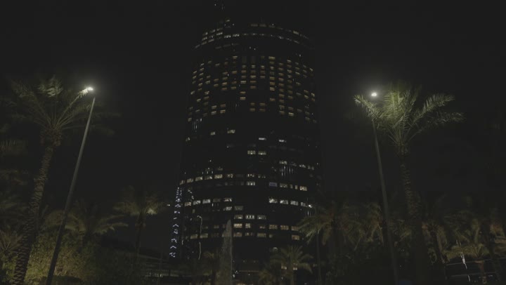 The famous Kingdom Tower illuminated at night in the city of Riyadh, the towers and skyscrapers, growth and development and urban progress, the lifestyle in the capital, the buildings and famous commercial landmarks, the architectural engineering art in a modern and advanced style.